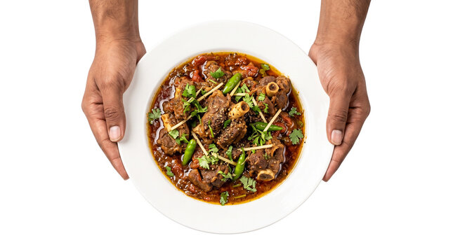 Traditional mutton karahi with ginger and green chilies, spicy lamb curry in white plate held by hands, authentic pakistani meat stew isolated PNG with Transparent Background