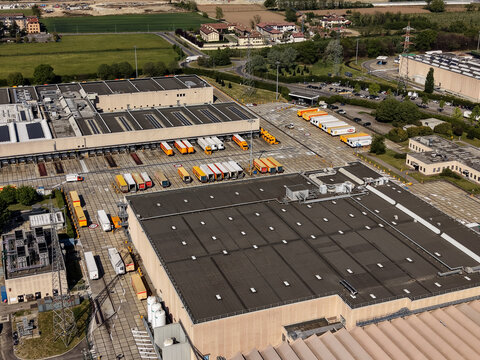 Pioltello, Lombardy, Italy - 18 May 2026: Aerial view of the Esselunga distribution center, featuring large warehouse buildings, loading docks with trucks, and industrial infrastructure.