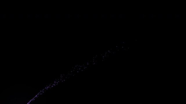 shooting star streaks across the sky.Meteor falling on black. particle 4k movie.