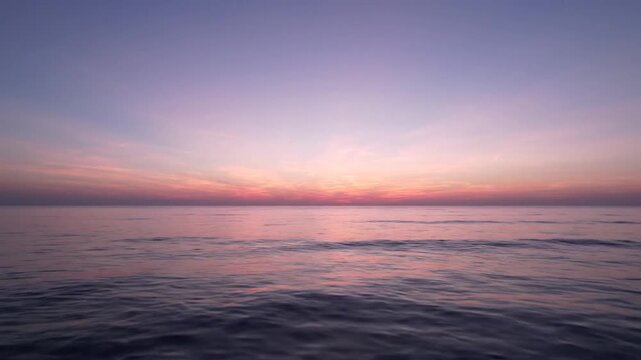 Calm ocean horizon during purple and pink sunset