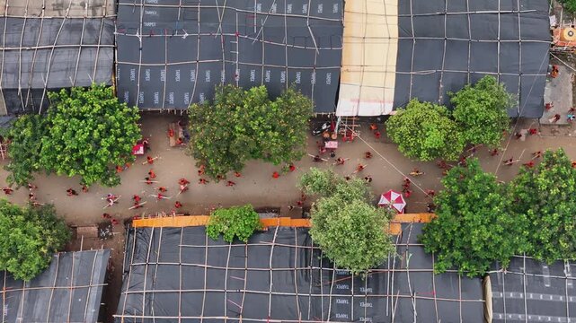 Aerial drone view of Kanwar Yatra pilgrims walking along the sacred route from Sultanganj to Deoghar during Shravan, capturing devotion, crowds, colorful kanwars, and India's largest annual pilgrimage
