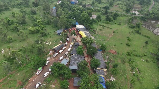 Aerial drone view of Kanwar Yatra pilgrims walking along the sacred route from Sultanganj to Deoghar during Shravan, capturing devotion, crowds, colorful kanwars, and India's largest annual pilgrimage