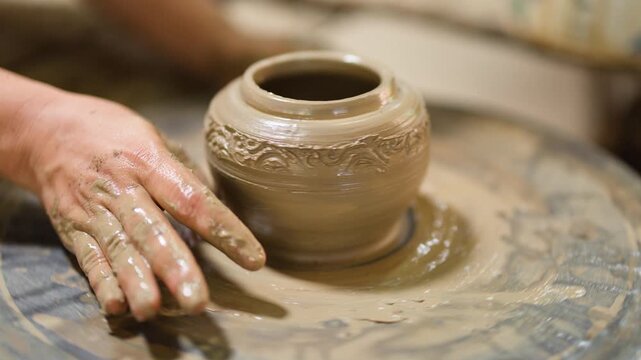 Artisan Hands Shaping Clay Pot on Spinning Pottery Wheel
