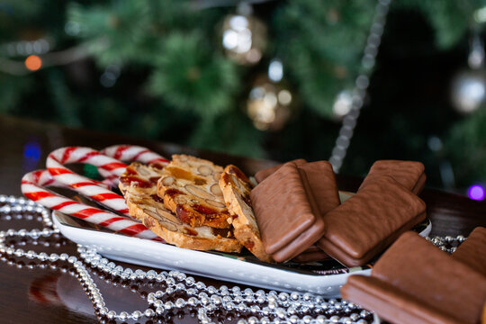Plate of sweet food on table with Christmas decor candy canes tim-tams and ginger biscuits