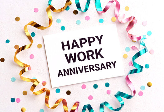Colorful happy work anniversary card with confetti and streamers on a light background celebration