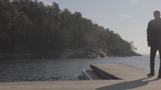Young traveler reflecting at the end of a scenic Scandinavian dock