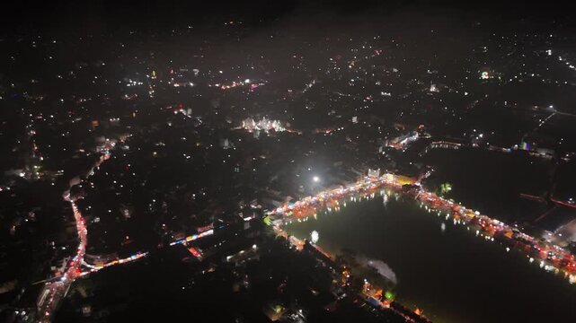 Aerial drone footage of Baba Baidyanath Dham in Deoghar at night, showcasing the illuminated temple complex, glowing city lights, surrounding streets, and the sacred Jyotirlinga pilgrimage site.