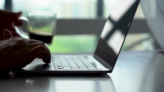 A Close-Up Look at a Modern Laptop and Coffee Cup: The Perfect Workspace Setup for Productivity and Focus in a Bright, Contemporary Environment