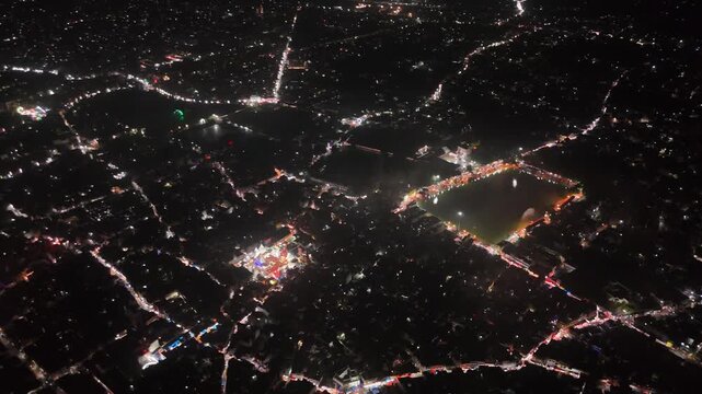 Aerial drone footage of Baba Baidyanath Dham in Deoghar at night, showcasing the illuminated temple complex, glowing city lights, surrounding streets, and the sacred Jyotirlinga pilgrimage site.