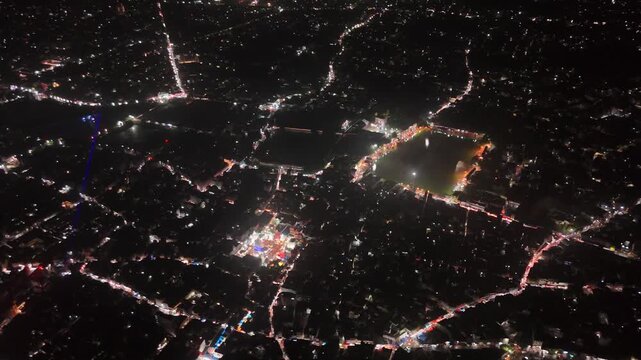 Aerial drone footage of Baba Baidyanath Dham in Deoghar at night, showcasing the illuminated temple complex, glowing city lights, surrounding streets, and the sacred Jyotirlinga pilgrimage site.