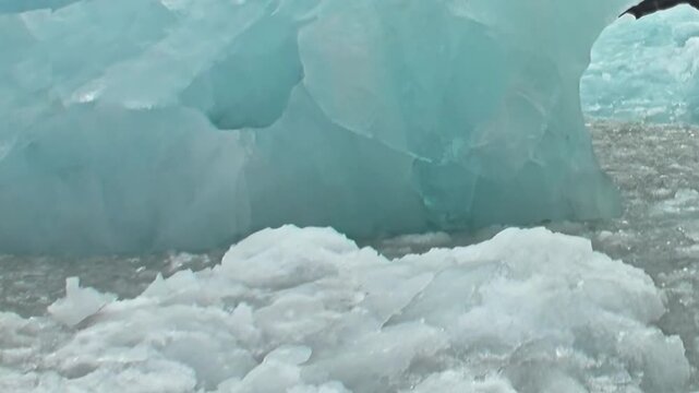 Observe monumental ice formations and delicate slush meandering through pristine, frigid Arctic Ocean. This captures raw beauty and challenging conditions of extreme travel in polar region.