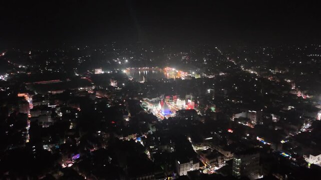 Aerial drone footage of Baba Baidyanath Dham in Deoghar at night, showcasing the illuminated temple complex, glowing city lights, surrounding streets, and the sacred Jyotirlinga pilgrimage site.