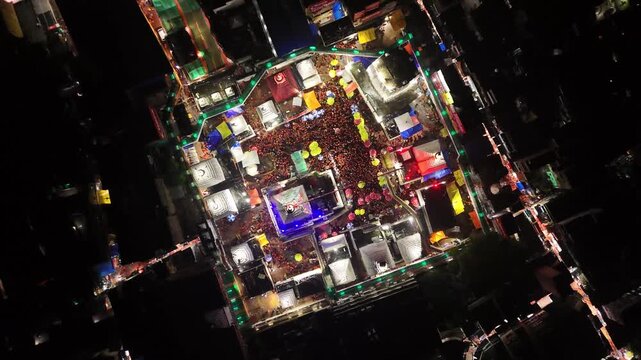 Aerial drone footage of Baba Baidyanath Dham in Deoghar at night, showcasing the illuminated temple complex, glowing city lights, surrounding streets, and the sacred Jyotirlinga pilgrimage site.