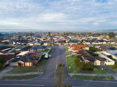 Aerial townscape of residential suburb in country town in Australia on morning with misty horizon