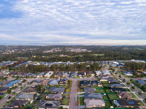 morning scene overlooking houses and rooftops of homes along street in Australian suburb
