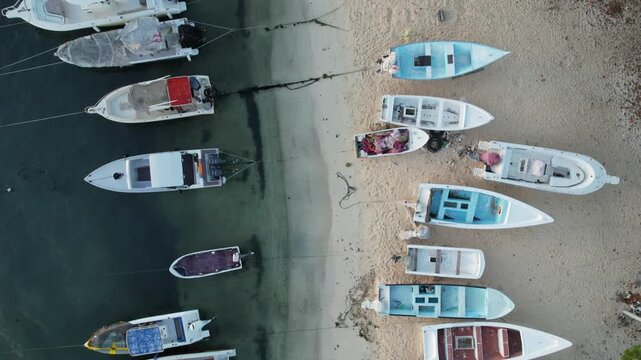 Los Roques, Venezuela - 01 January 2025: Aerial view of small boats moored along the sandy beach of the Los Roques archipelago.