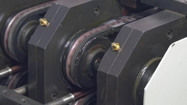 Close-up imagery reveals intricate mechanics of industrial machine crafting copper tubes. Observe slow motion as raw materials become essential components for air conditioners in factory setting.