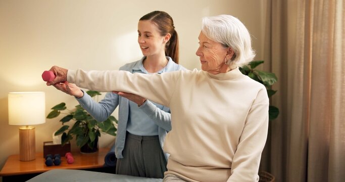 Physiotherapist, senior and woman with dumbbell in private practice for weightlifting or session. Female person, coach or therapist with elderly client or weight for muscle recovery or rehabilitation
