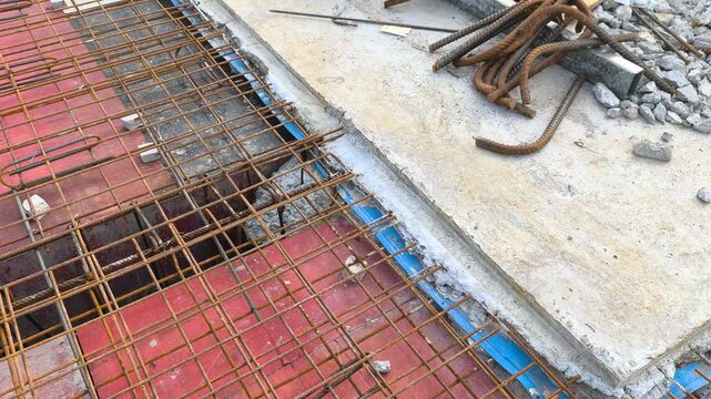 A blue rubber waterstop is installed along a concrete slab construction joint. It acts as a barrier to prevent water ingress through roof slab joints. The fitting ensures structural waterproofing.