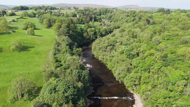 Aerial drone view flying over the river ure close to Aysgarth Falls in the Yorkshire Dales
