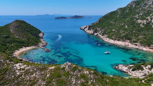 Kerkira, Corfu, Greece - 29 June 2026: Aerial view of Porto Timoni beach with turquoise waters, rocky cliffs, and boats in the Ionian Sea.