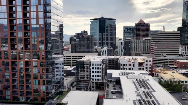 Salt Lake City, Utah, United States - 05 July 2026: Aerial view of a downtown apartment construction site showing adaptive reuse of older buildings for new residential housing.