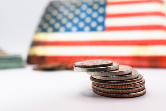 Close up of stacking coins against the backdrop of the American flag, USA one cent, US dollars, Money growing concept. The dime and the pennies