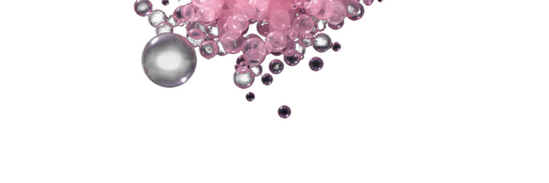 Floating pink soap bubbles on black background