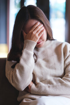 Vertical of a woman with feeling sad and stressed, sick and headache concept