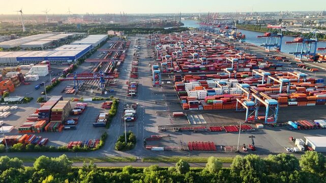Hamburg, Germany - 01 July 2026: Aerial view of Container-Terminal-Altenwerder showing rows of colorful shipping containers, gantry cranes, and logistics infrastructure.
