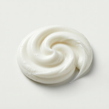 Swirl of white toothpaste on white background. Creamy cosmetic texture for skincare.