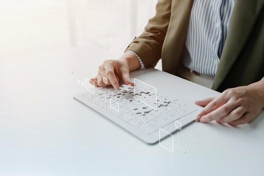 Business professional assembling puzzle pieces on a digital board, symbolizing strategic planning, problem solving, teamwork, organization, innovation, and business solutions.