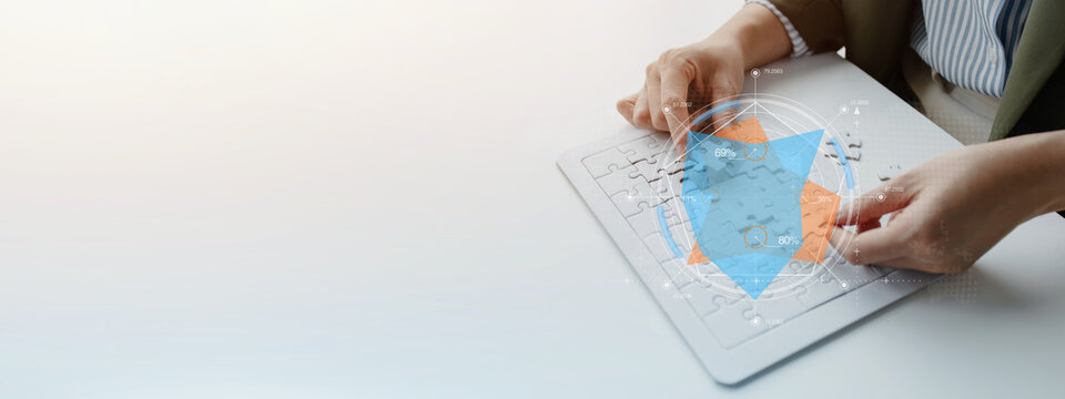 Business professional arranging colorful puzzle pieces on a digital board, representing creative strategy, problem solving, teamwork, planning, innovation, and business development.