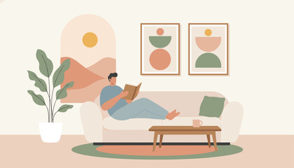 Fototapeta premium Cozy modern living room interior with a young man comfortably relaxing on a sofa while reading an interesting book.