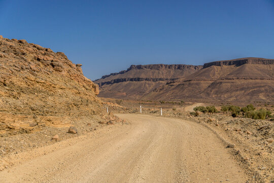 Rocky road through Adrar Plateau and Amojjar Pass at Western Sahara landscape of Sahel and Sahara desert, Mauritania.
