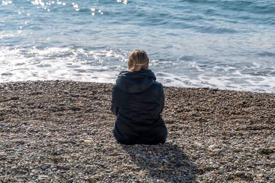 Woman Beach Solitude: Seashore Contemplation, Coastal Scene, Winter Daytime