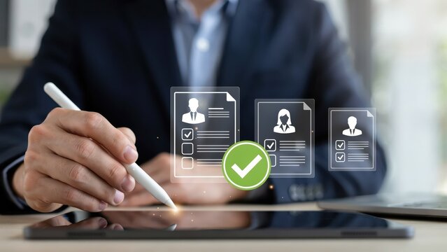 Business person using a digital pen on a tablet to review and approve virtual candidate profiles for recruitment.