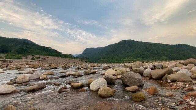 Scenic landscape of mountain river stream with Meghalaya hills and dramatic sky in Bichanakandi, Sylhet, Bangladesh