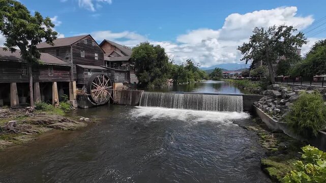 Wide angle view of the Old Mill Restaurant in Pigeon Forge, Tennessee featuring wooden waterwheel in the Great Smokiy Mountains