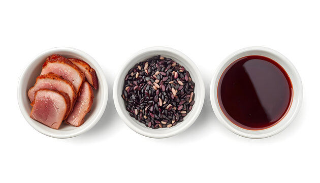 Seared duck breast with black rice and sauce. Gourmet meal served in three white bowls.