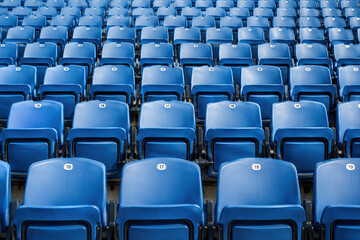 Naklejka premium Empty Rows of Blue Stadium Seats Ready for Event