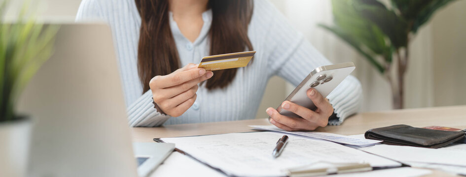 person pay bills via mobile banking at home