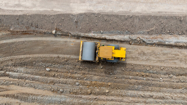 Aerial view motor grader civil at construction site, Motor grader work on construction site, Road grader on road construction site machine work on the construction of new road.