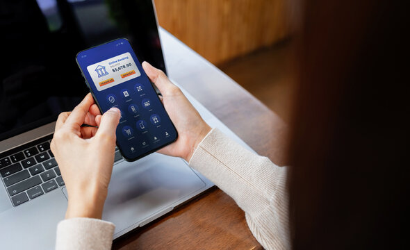 Person using a smartphone with a mobile banking application. Concept of digital payment, online finance, fintech, cashless transactions and banking.