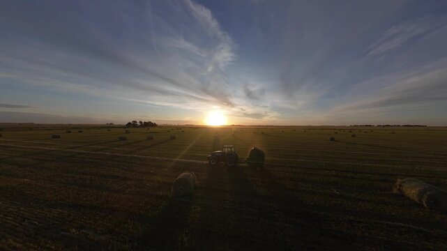 Tractor with baler during the golden hour.