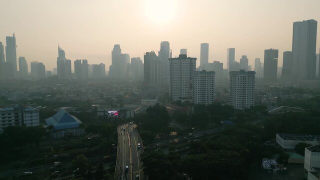 Aerial View of City Skyline Covered in Smog During Hazy Sunrise