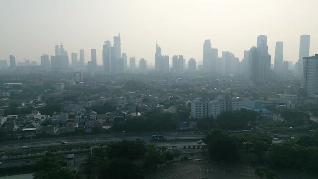 Urban Skyline and Highway Traffic Shrouded in Heavy Smog at Sunrise