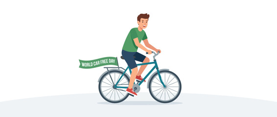 Fototapeta premium Man riding bicycle with 'World Car Free Day' banner