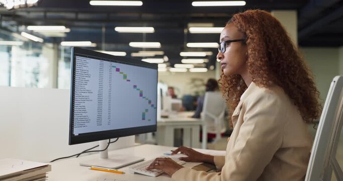 Businesswoman analyst analyzing data on computer monitor. Focused professional reviews finance spreadsheet in office, tracking budgets and timelines. Clear concept of data driven planning.