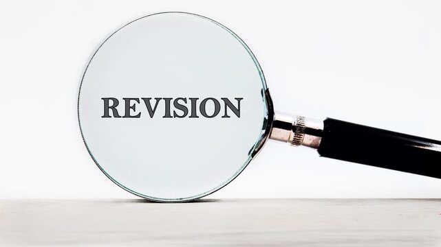 A person uses a magnifying glass to see how text appears when magnified. Different words shift into focus as the glass moves closer